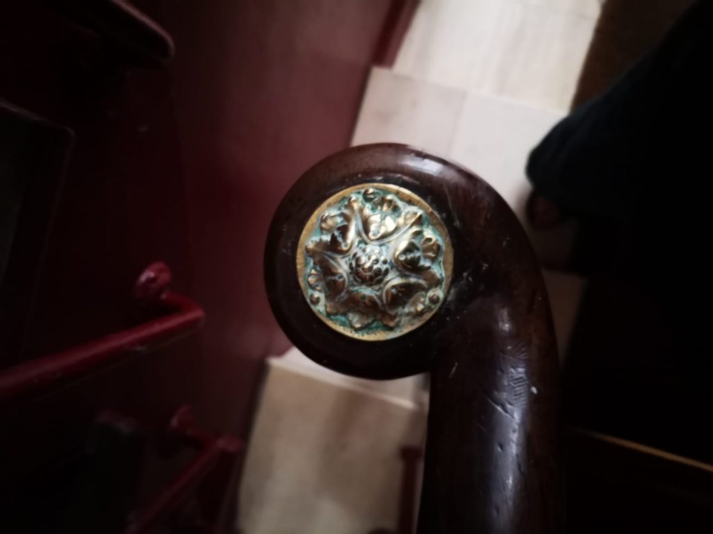 Brass decorative motif at the end of the stair handrail